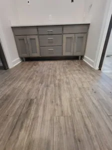 Gray vanity cabinet with drawers and doors installed, countertop not yet in place.
