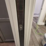Close-up of a pocket door hardware installation, showcasing the track and roller mechanism. This detail highlights the precision required for smooth operation.