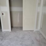 Bi-fold closet door slabs installed and painted white in finished opening.