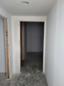 Doorway opening with drywall finished around it, ready for jamb and casing installation