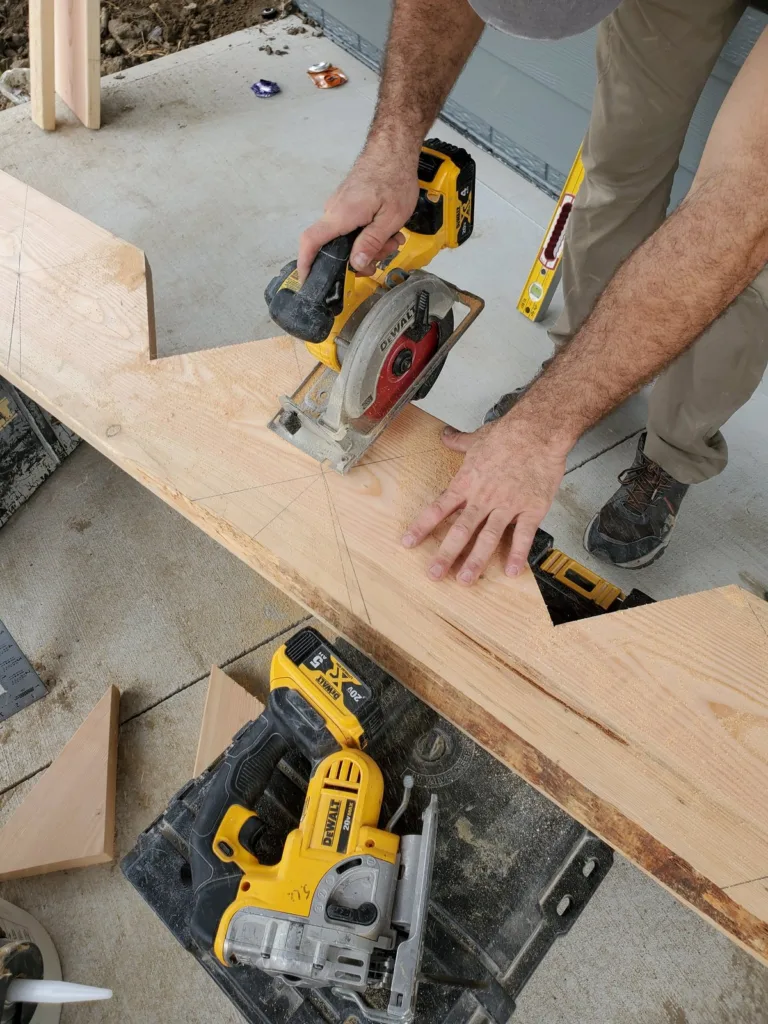 Circular saw cutting a stringer notch along the layout line, cut out waste pieces below the board
